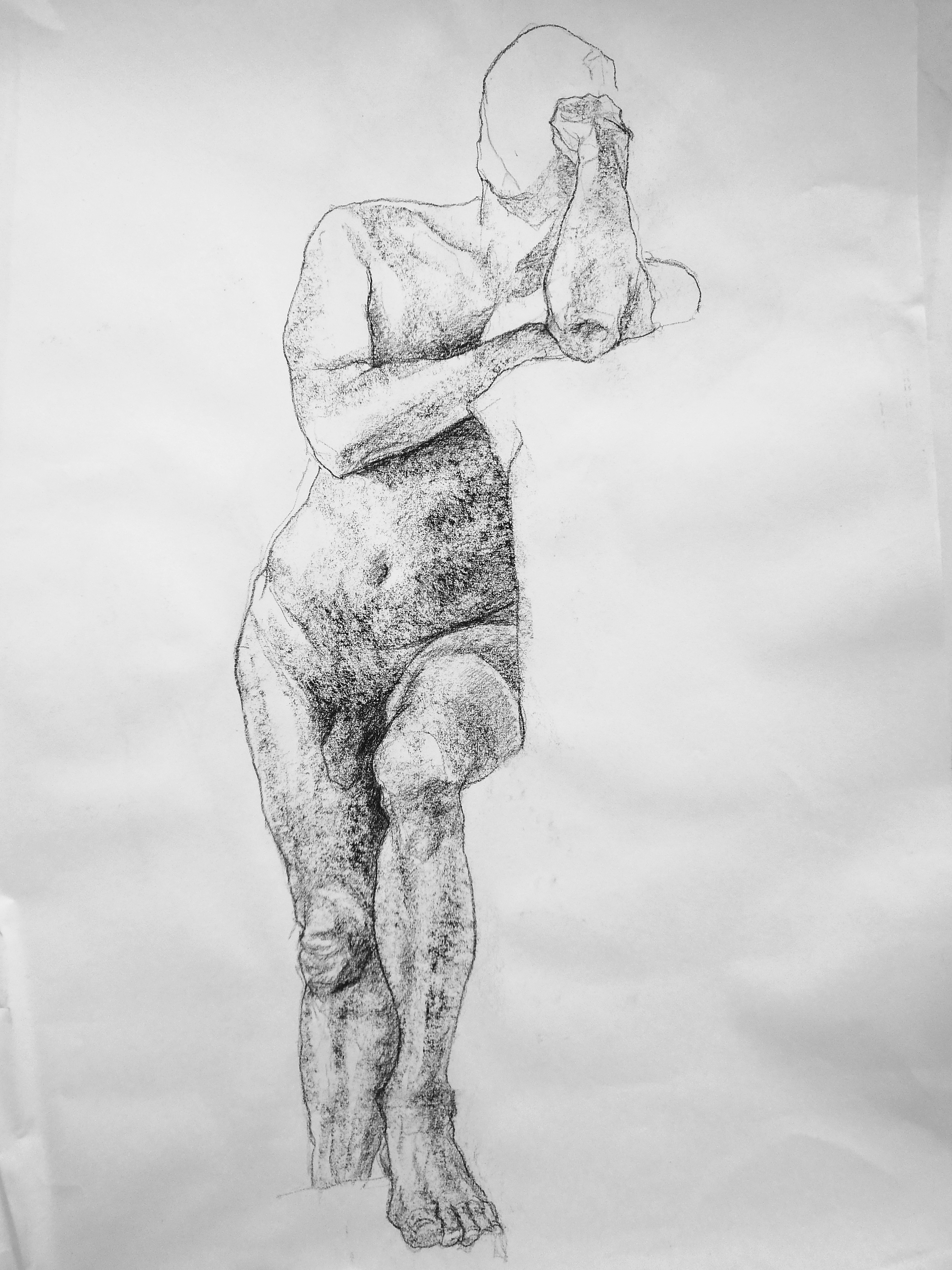 A faceless naked man standing with one foot resting on the support.