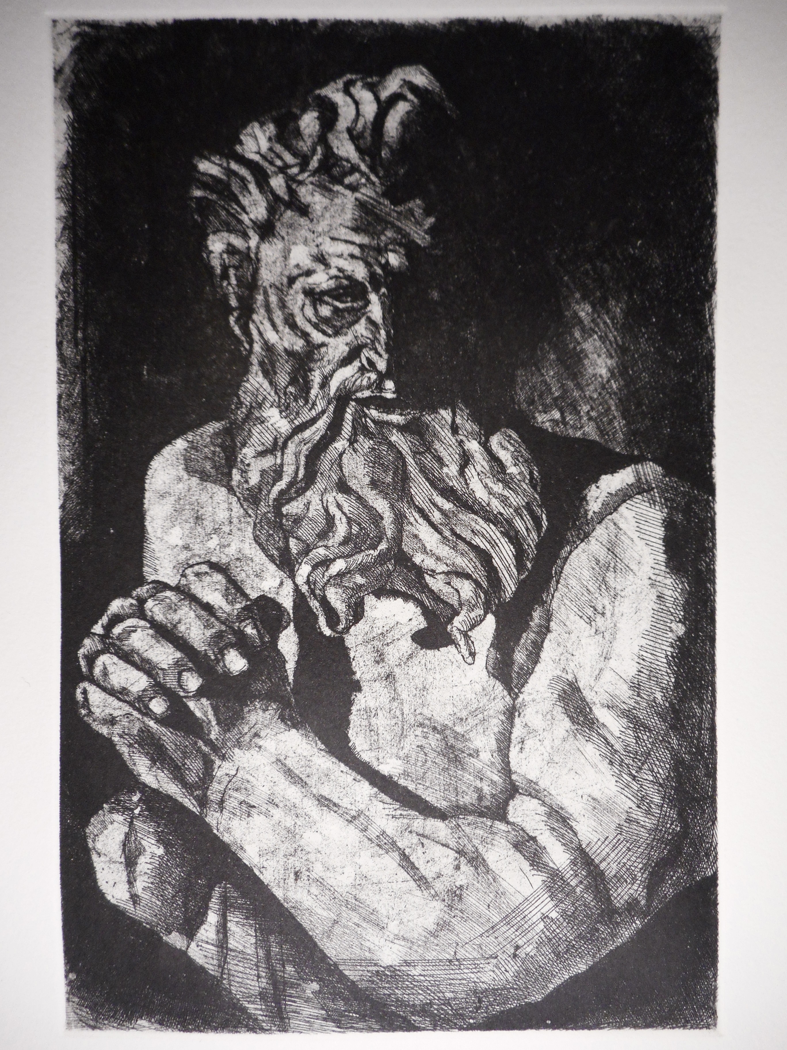 A bearded mythical character joins his hands in prayer.