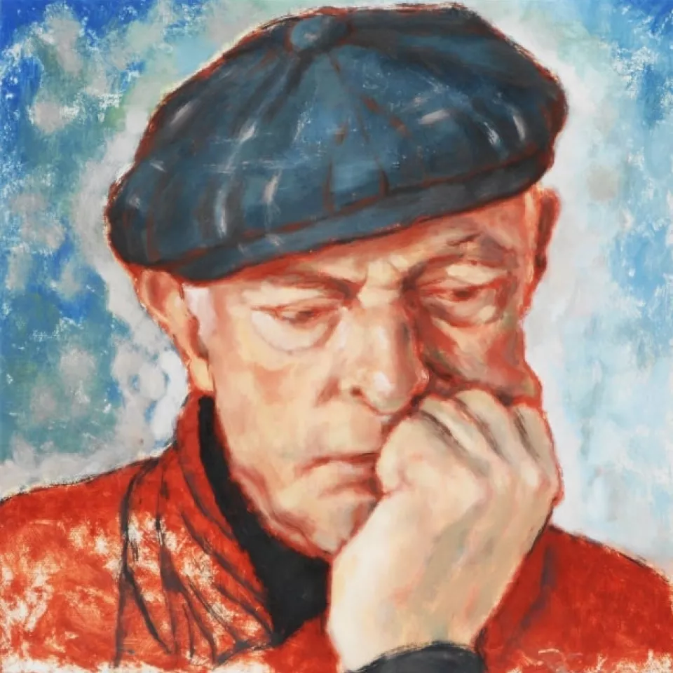 A pensive old man in a blue beret holds his head with his fist.